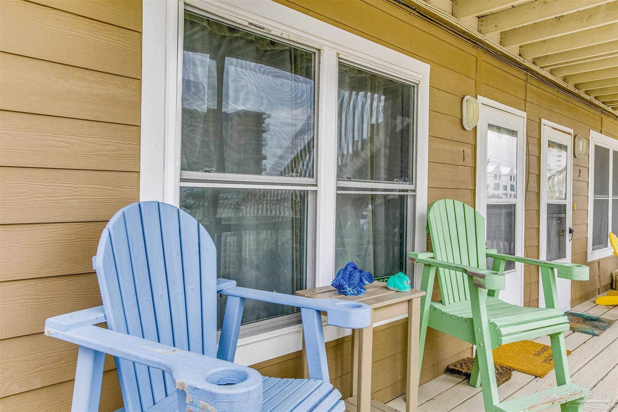 a view of balcony with two chairs and wooden floor