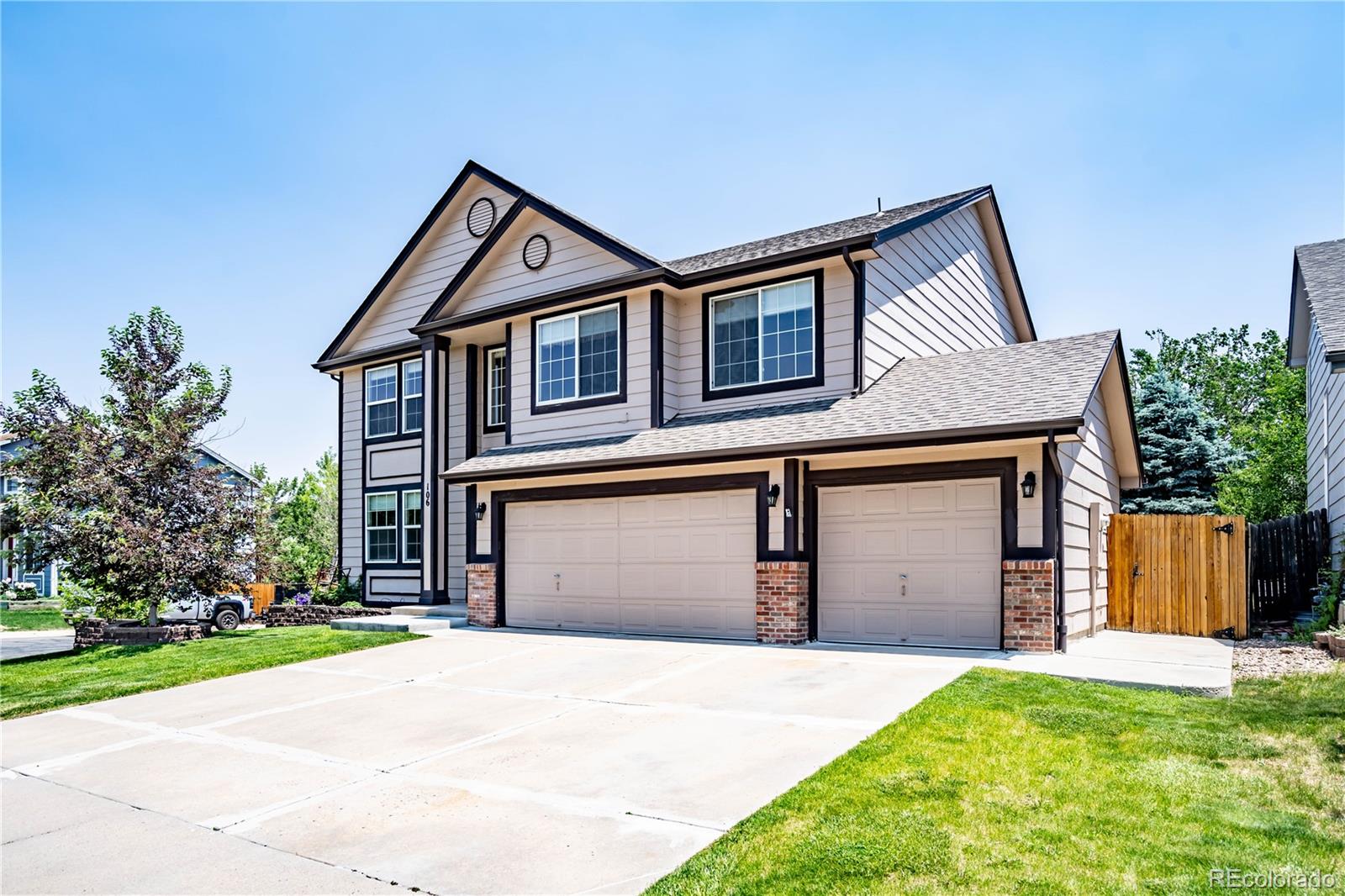 a front view of a house with a yard and garage