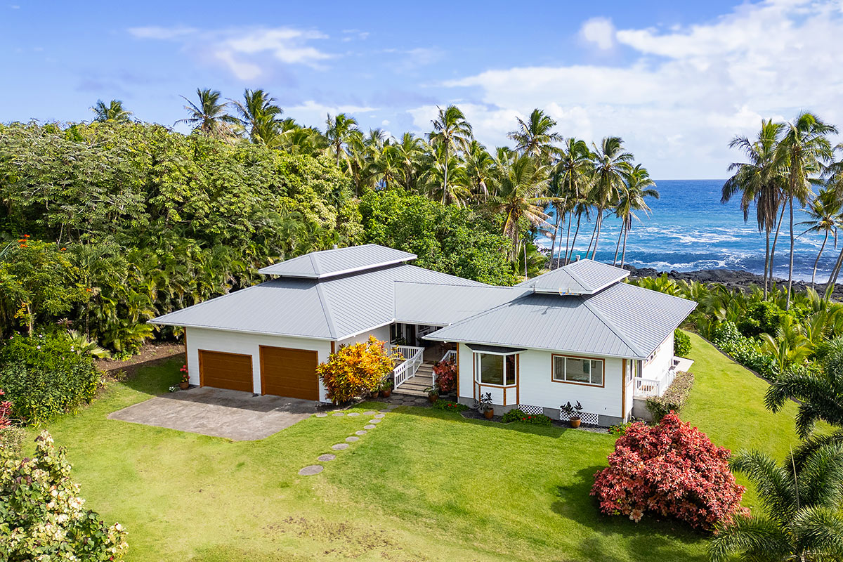 a aerial view of a house with swimming pool and a yard