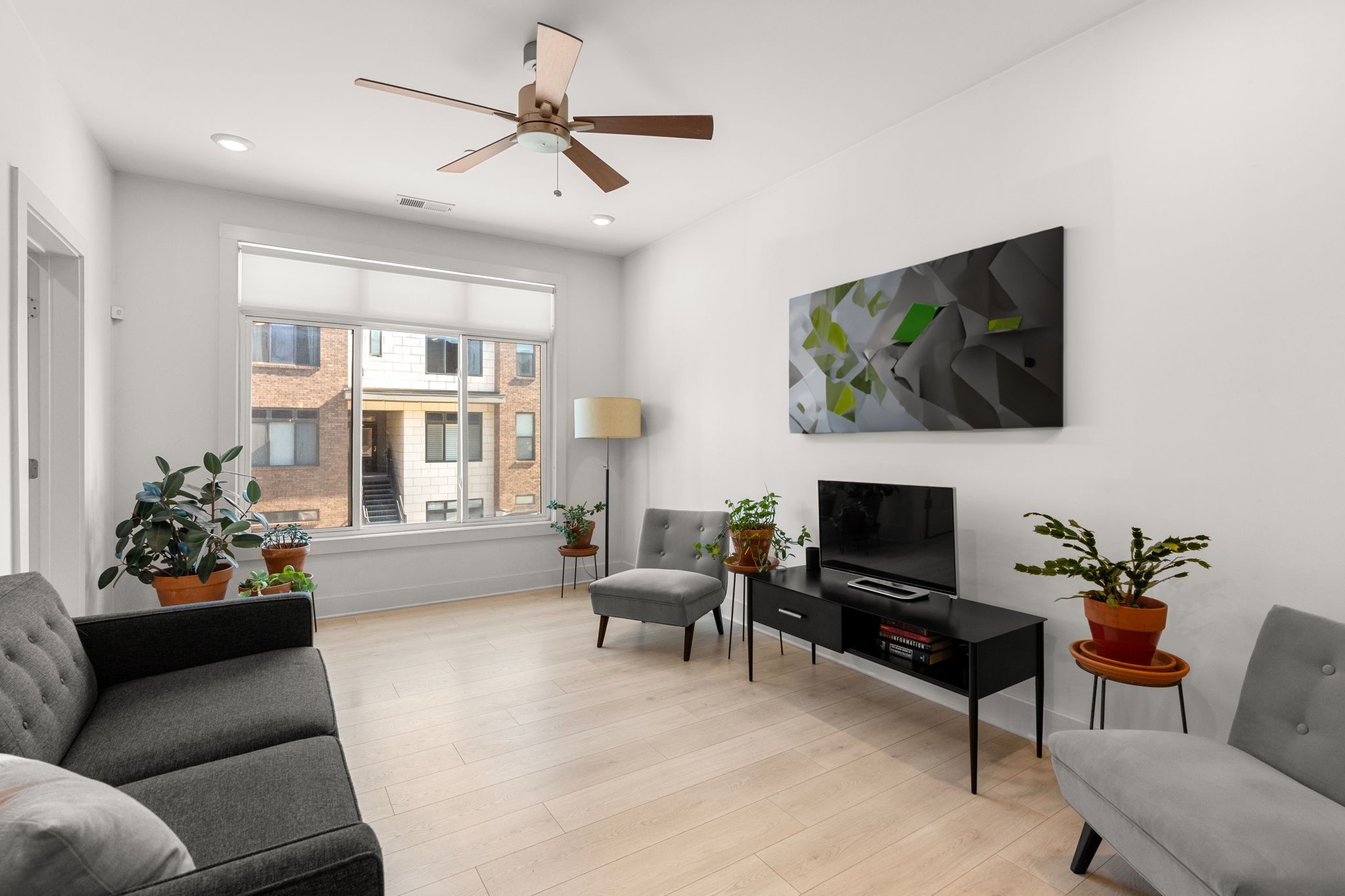 a living room with furniture a flat screen tv and a fireplace