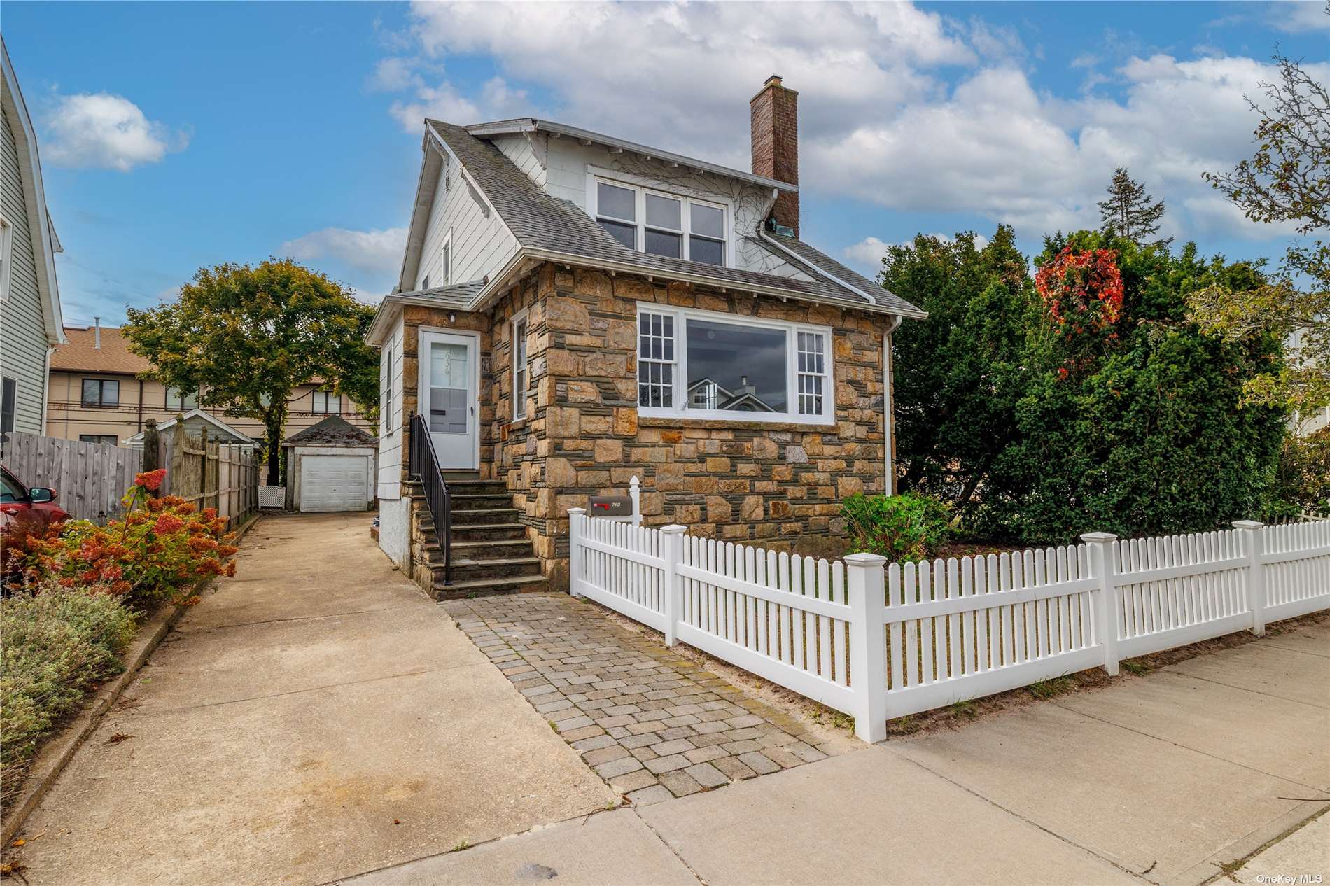 a front view of a house with iron fence