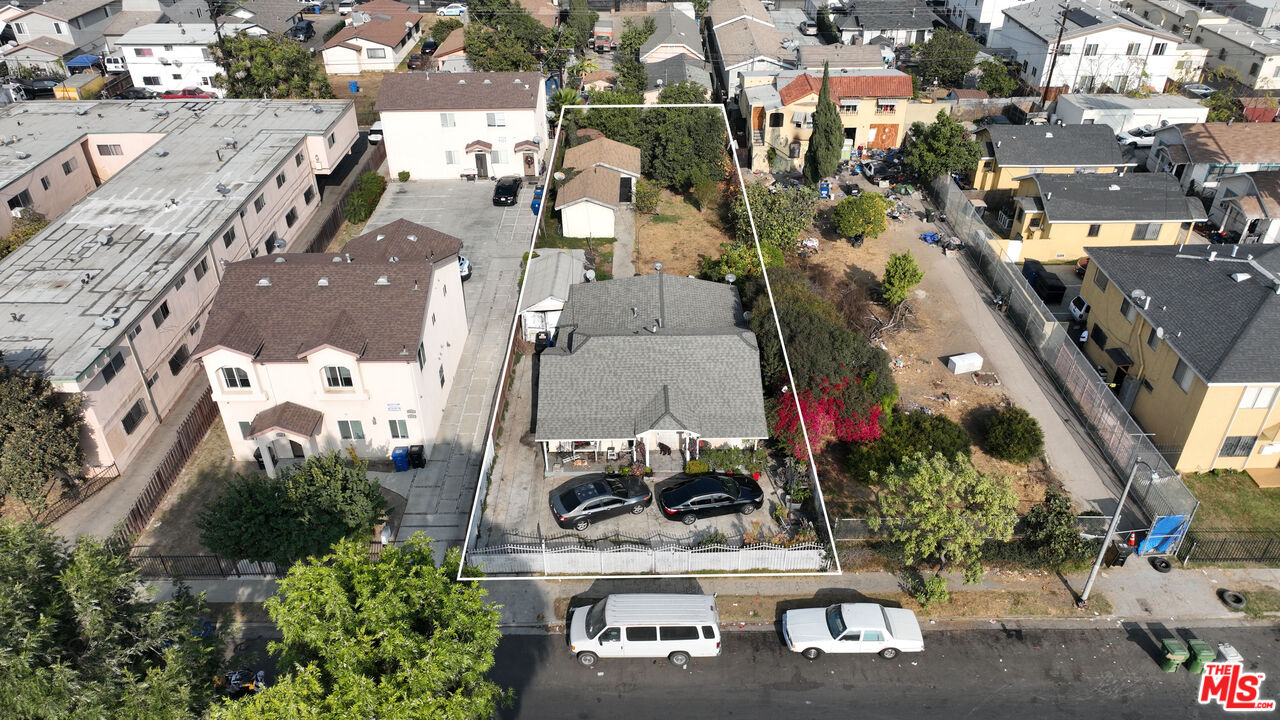 an aerial view of multiple houses with yard