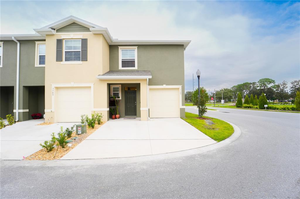 a view of house with outdoor space and parking