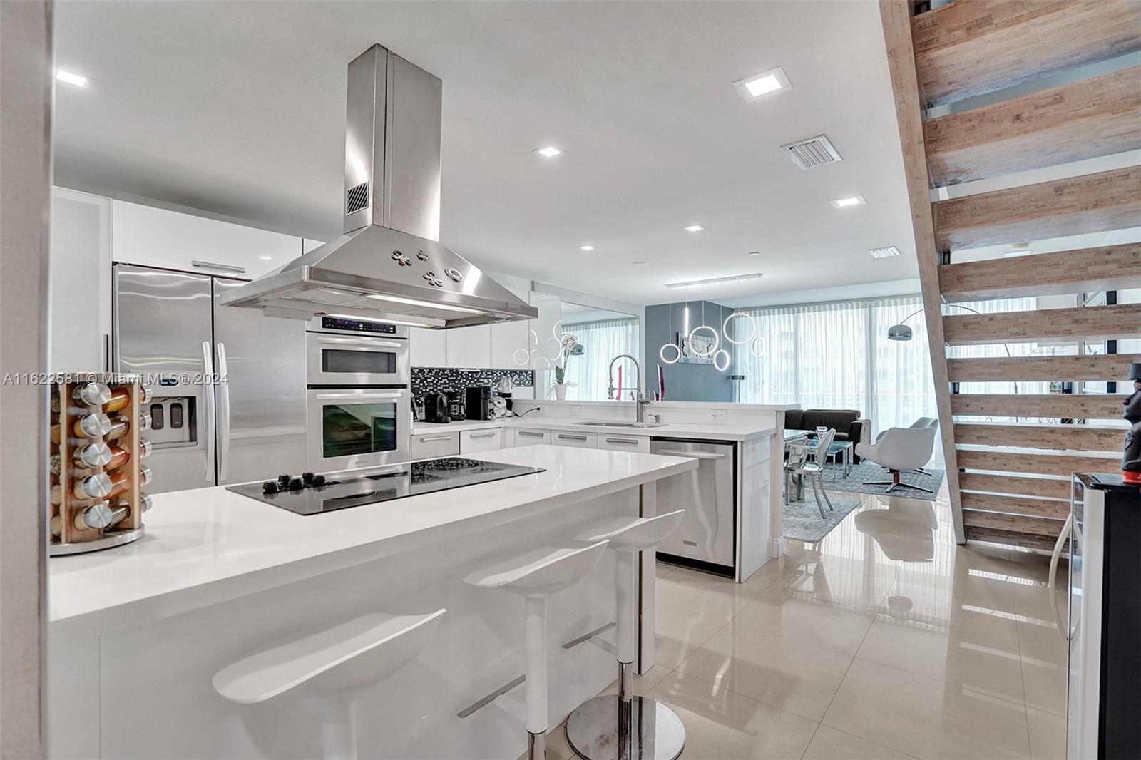 a kitchen with a sink stainless steel appliances and cabinets