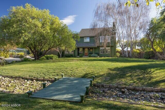 a view of a house with a yard