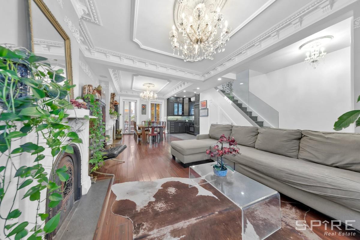 a living room with furniture and a chandelier