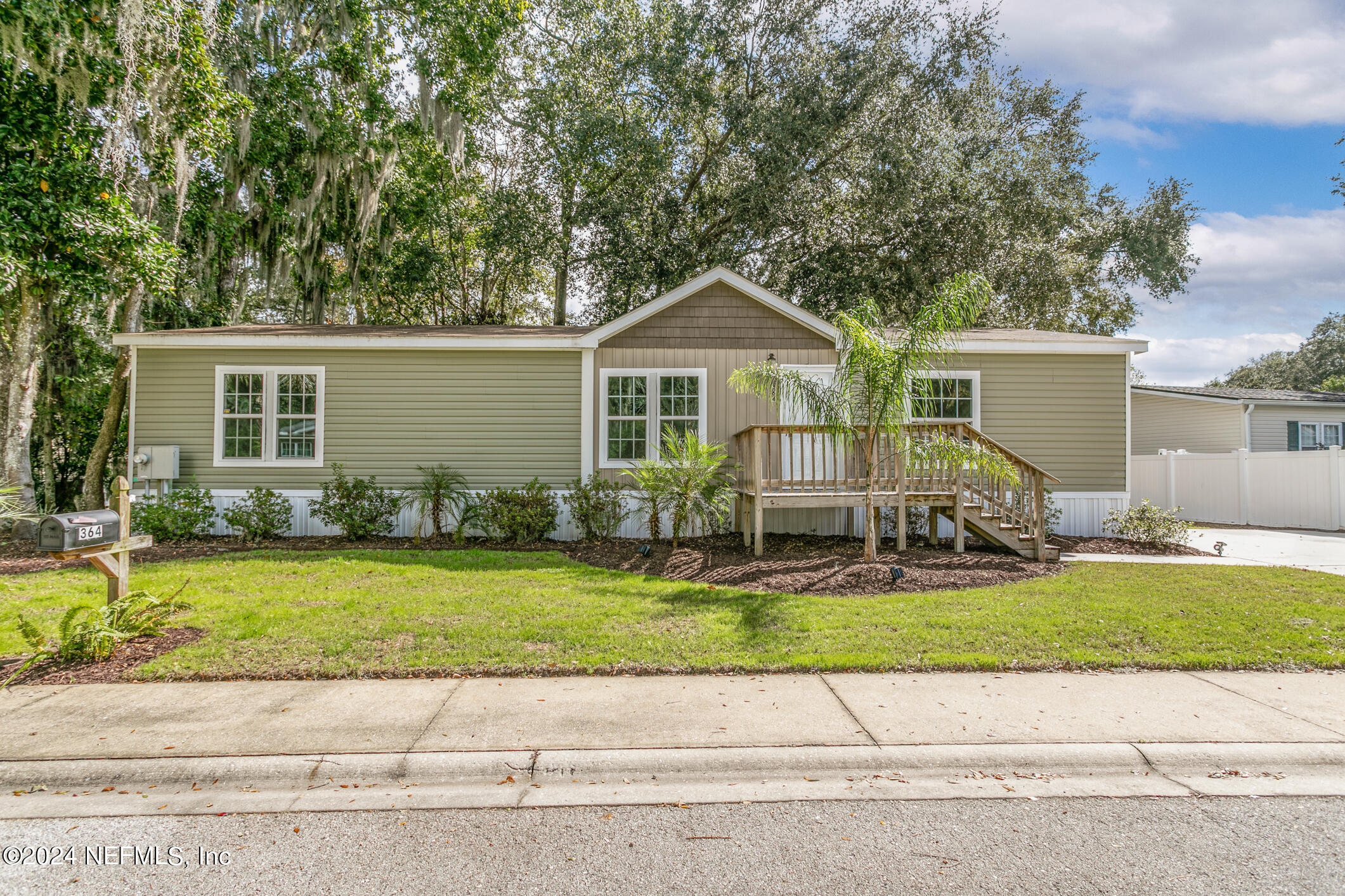 a front view of house with yard and outdoor seating