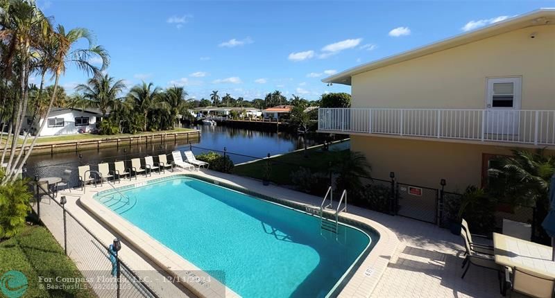 a view of a swimming pool and outdoor seating