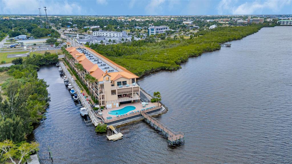 an aerial view of a house with a yard and lake view