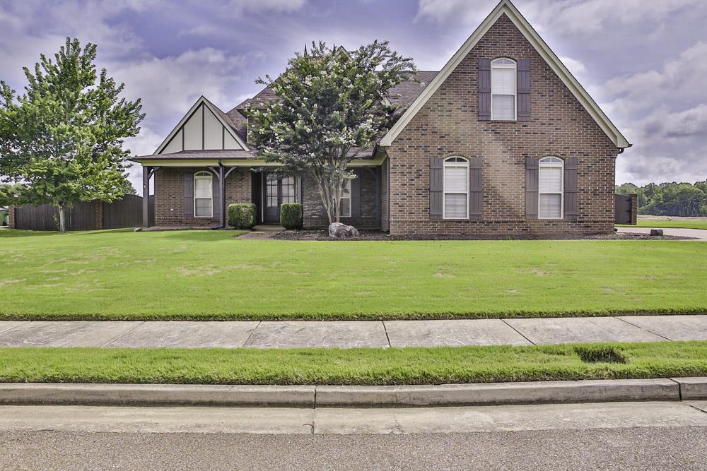 a view of a house with a swimming pool and a yard