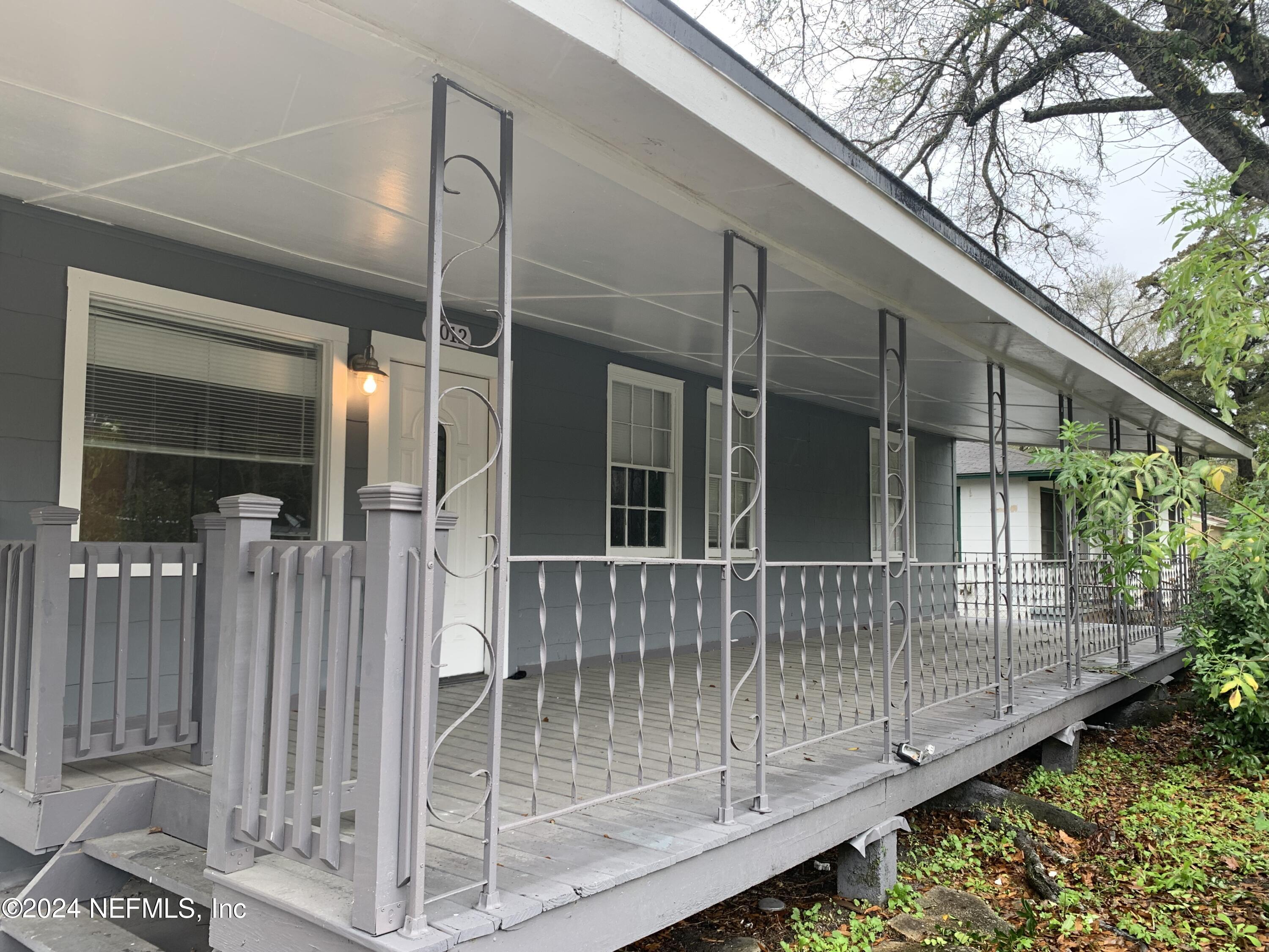 a view of a house with a wooden deck