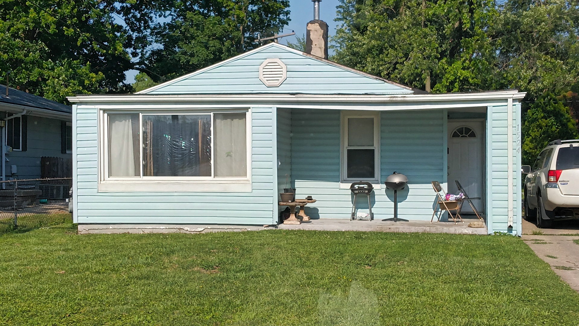 a front view of house with yard and outdoor seating