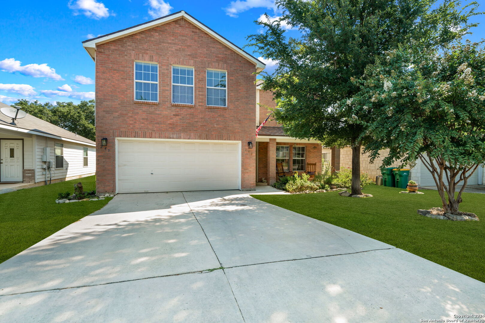 a front view of house with yard and green space