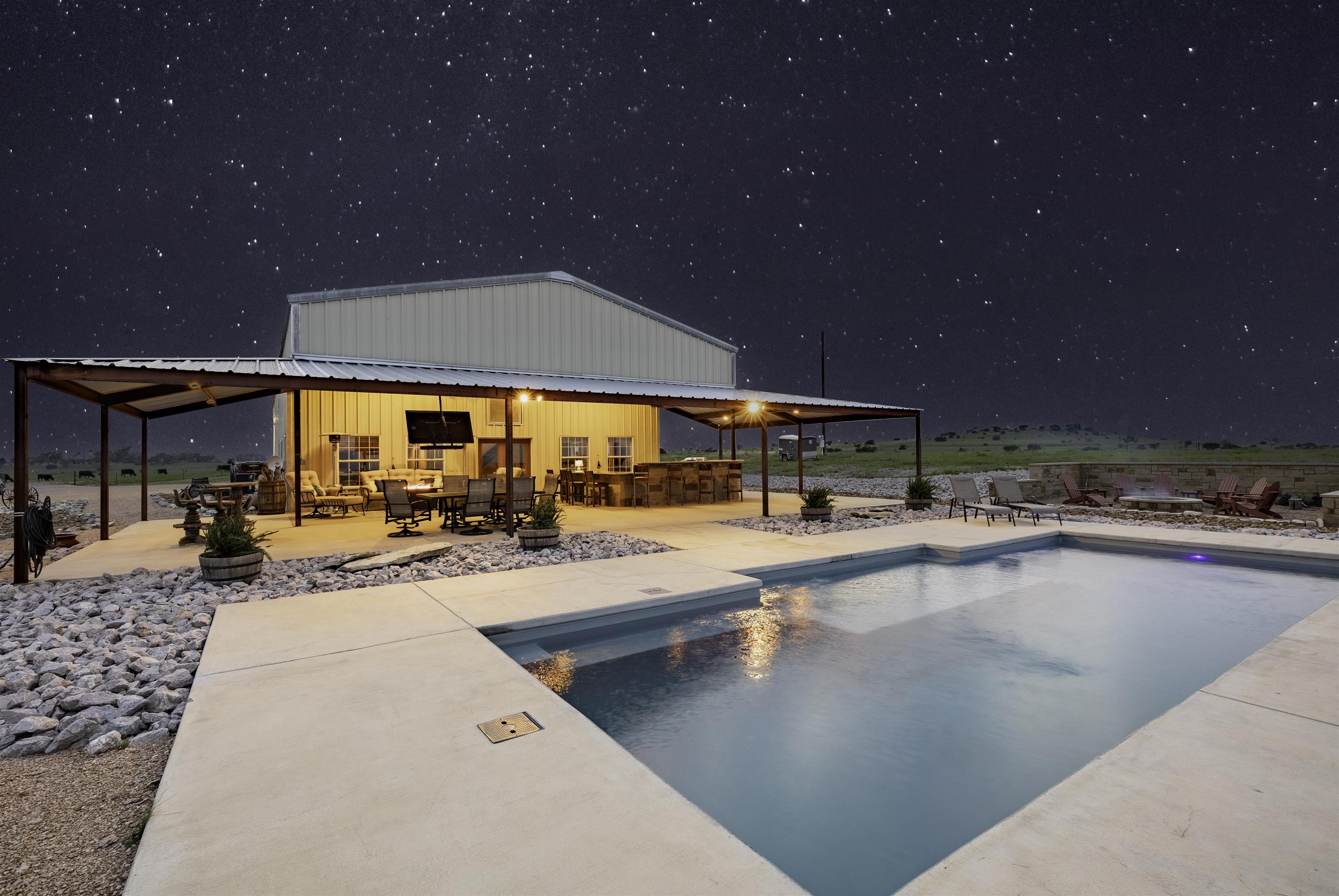 a view of a swimming pool with outdoor seating