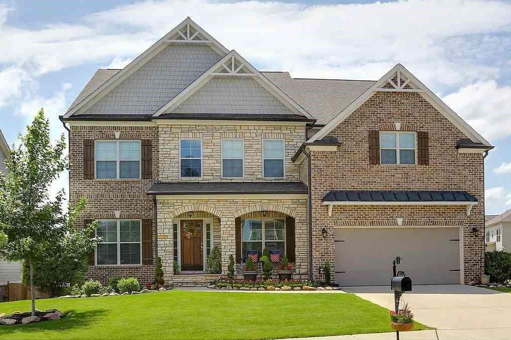 a front view of a house with garden