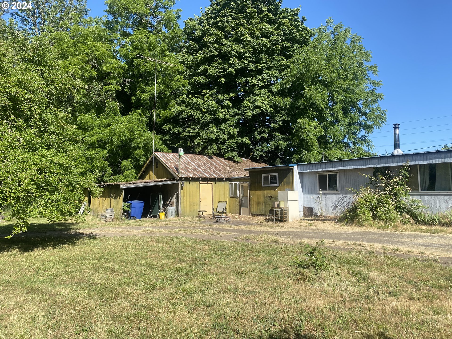 a front view of a house with a yard and potted plants