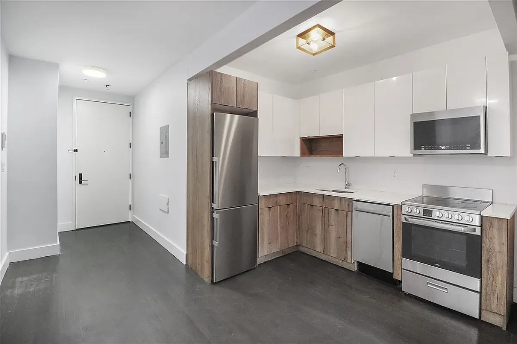 a kitchen with a refrigerator stove and microwave