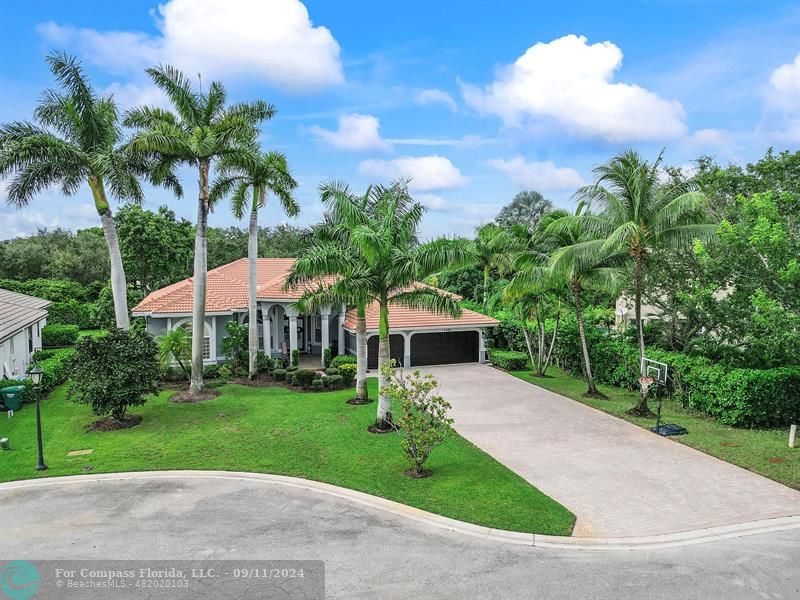 Beautiful oversized lot with new roof "2020" and new pavers "2024' for the long long driveway that can hold many autos, Hurricane impact garage doors, Lush landscaping 2024