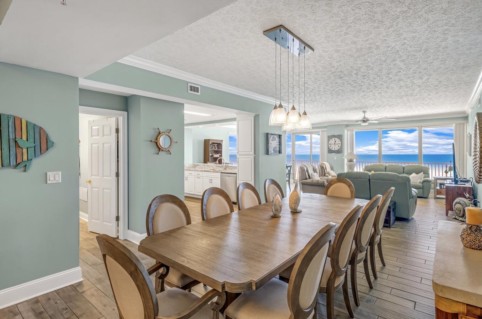 a dining room with furniture a chandelier and window