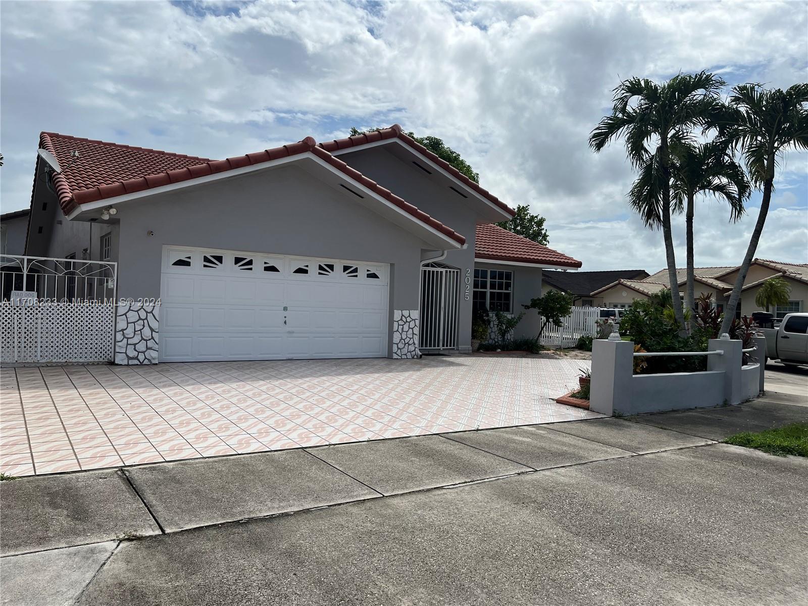 a view of a house with a backyard and a garage