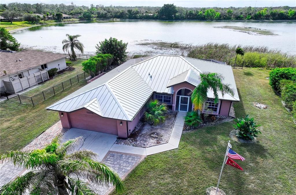 Birds eye view of property with a water view