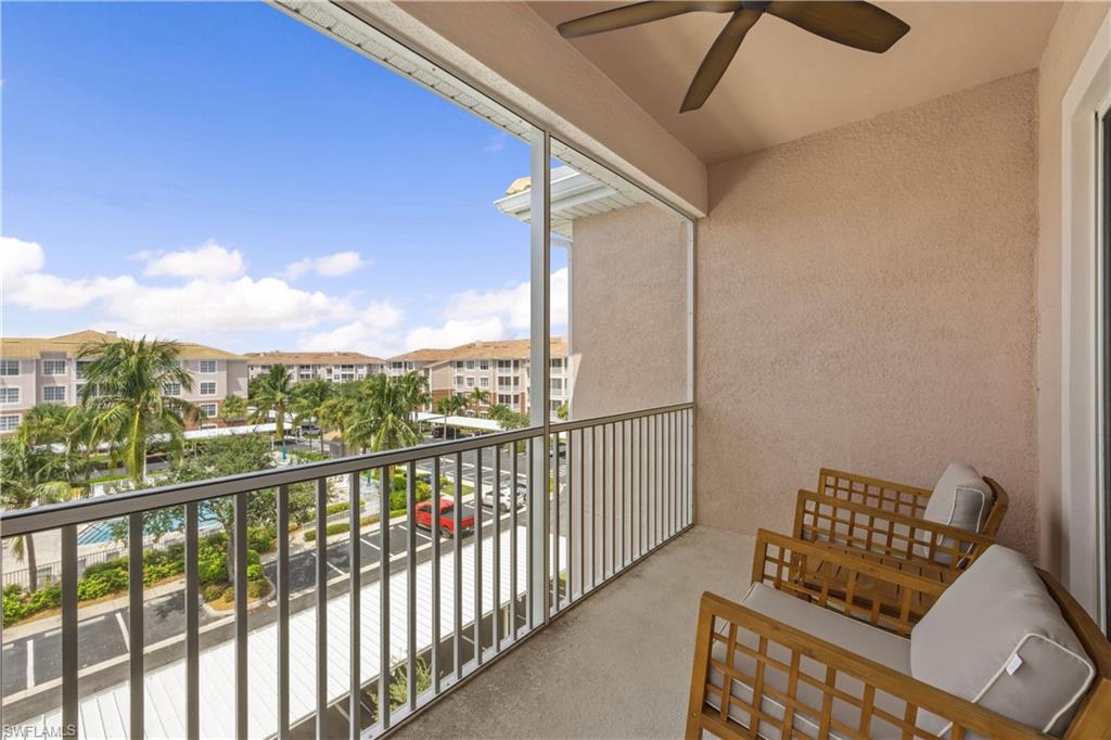 Balcony with ceiling fan and view of the pool