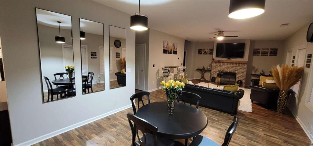 a living room with furniture kitchen view and a chandelier