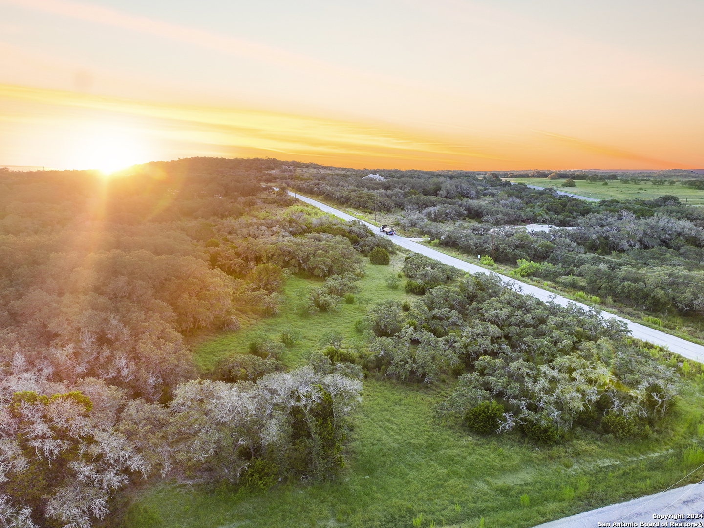 a view of a field with an ocean