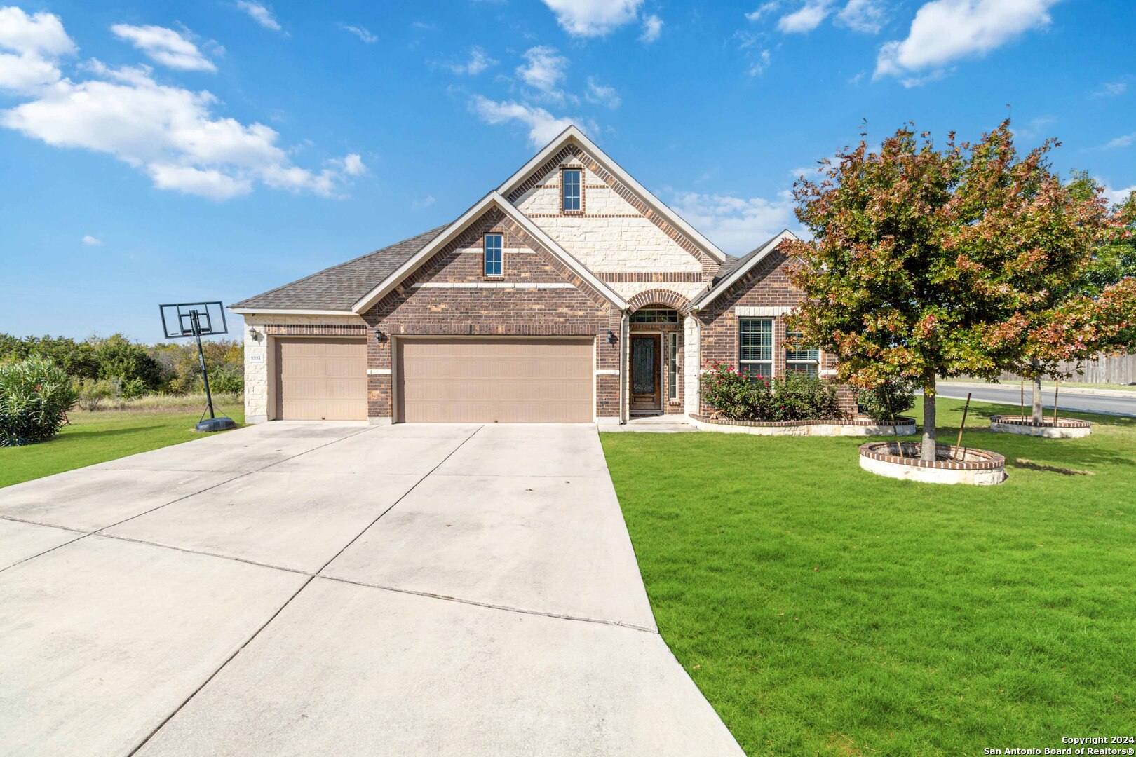 a front view of house with yard and green space