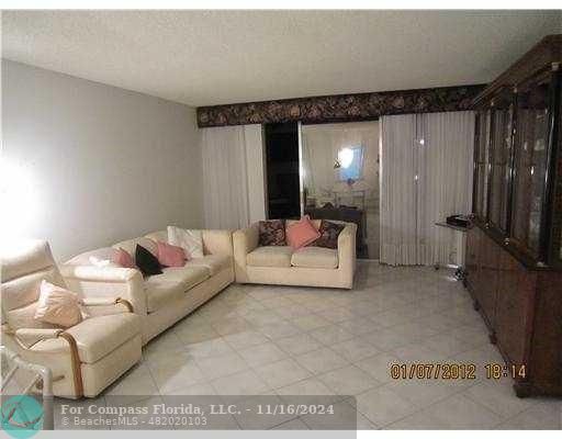 a living room with furniture and a large mirror