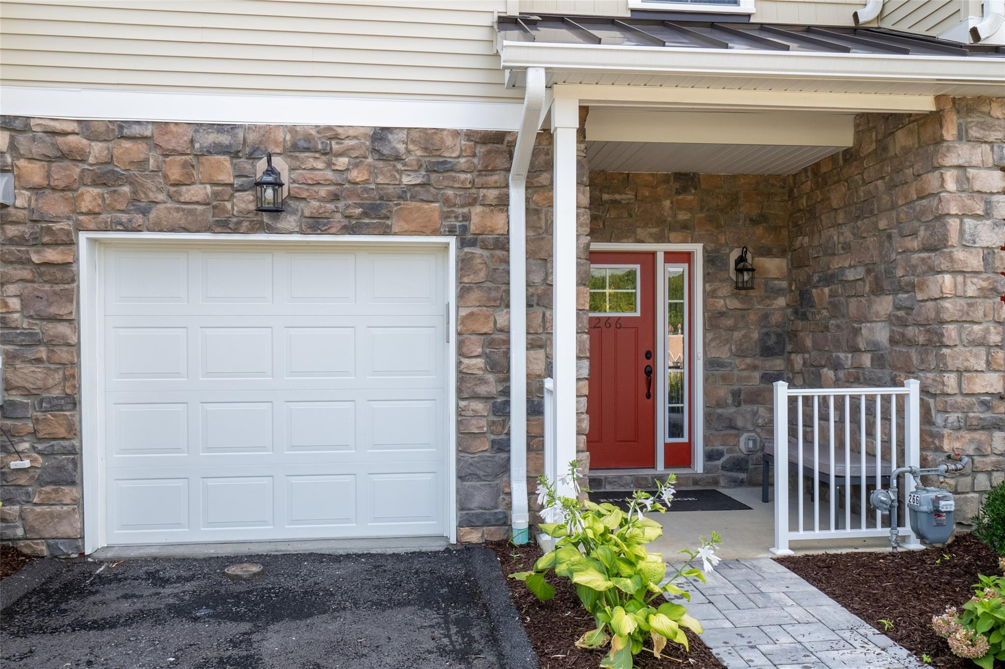 View of exterior entry featuring a garage