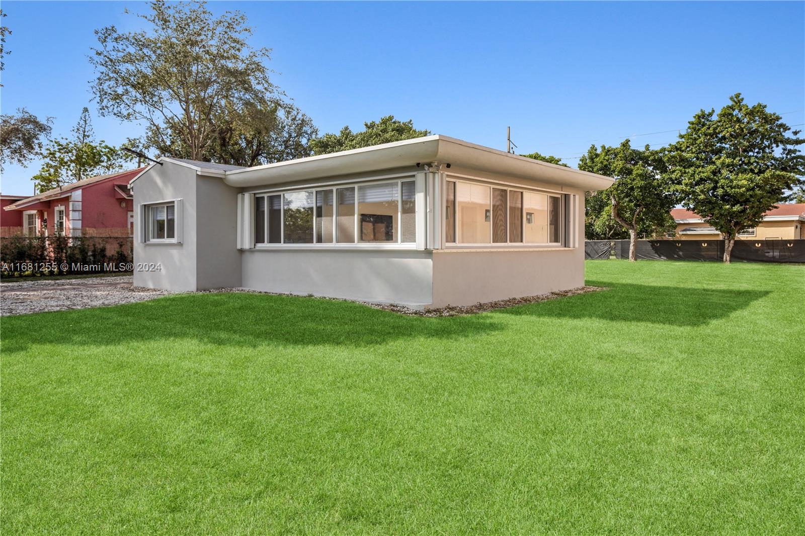 a front view of house with yard and green space