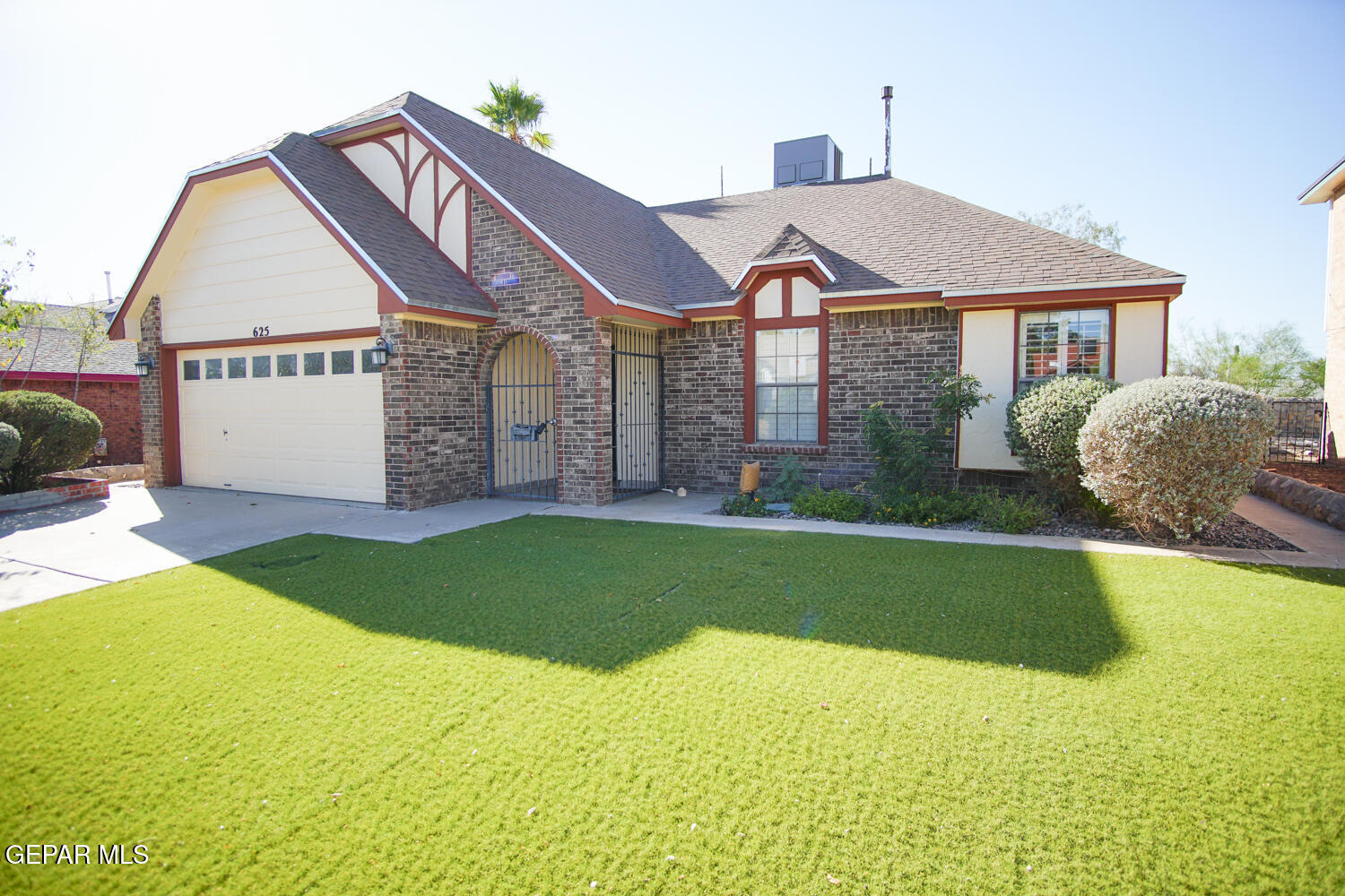 a front view of a house with garden