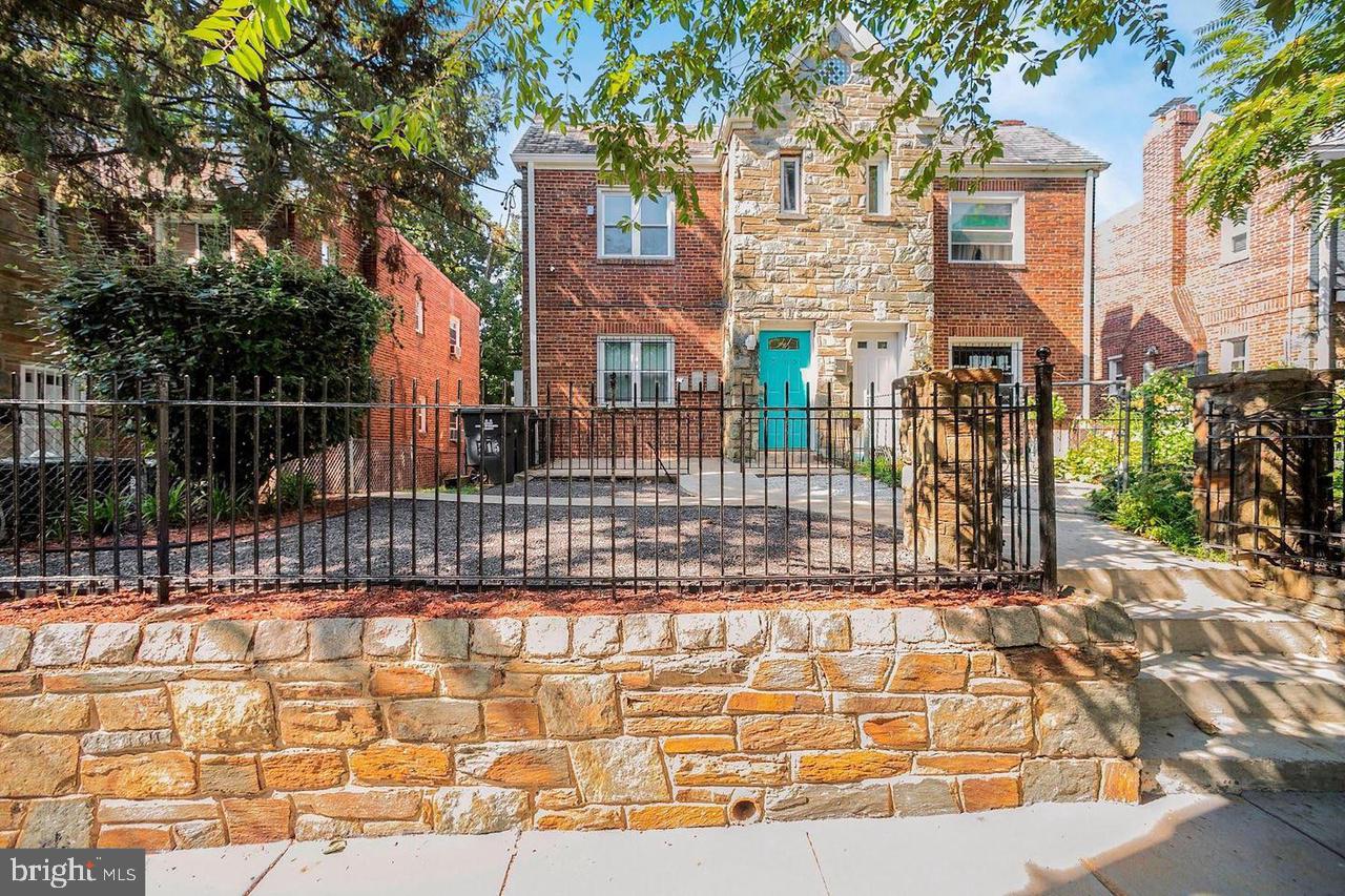 a view of a brick house with many windows