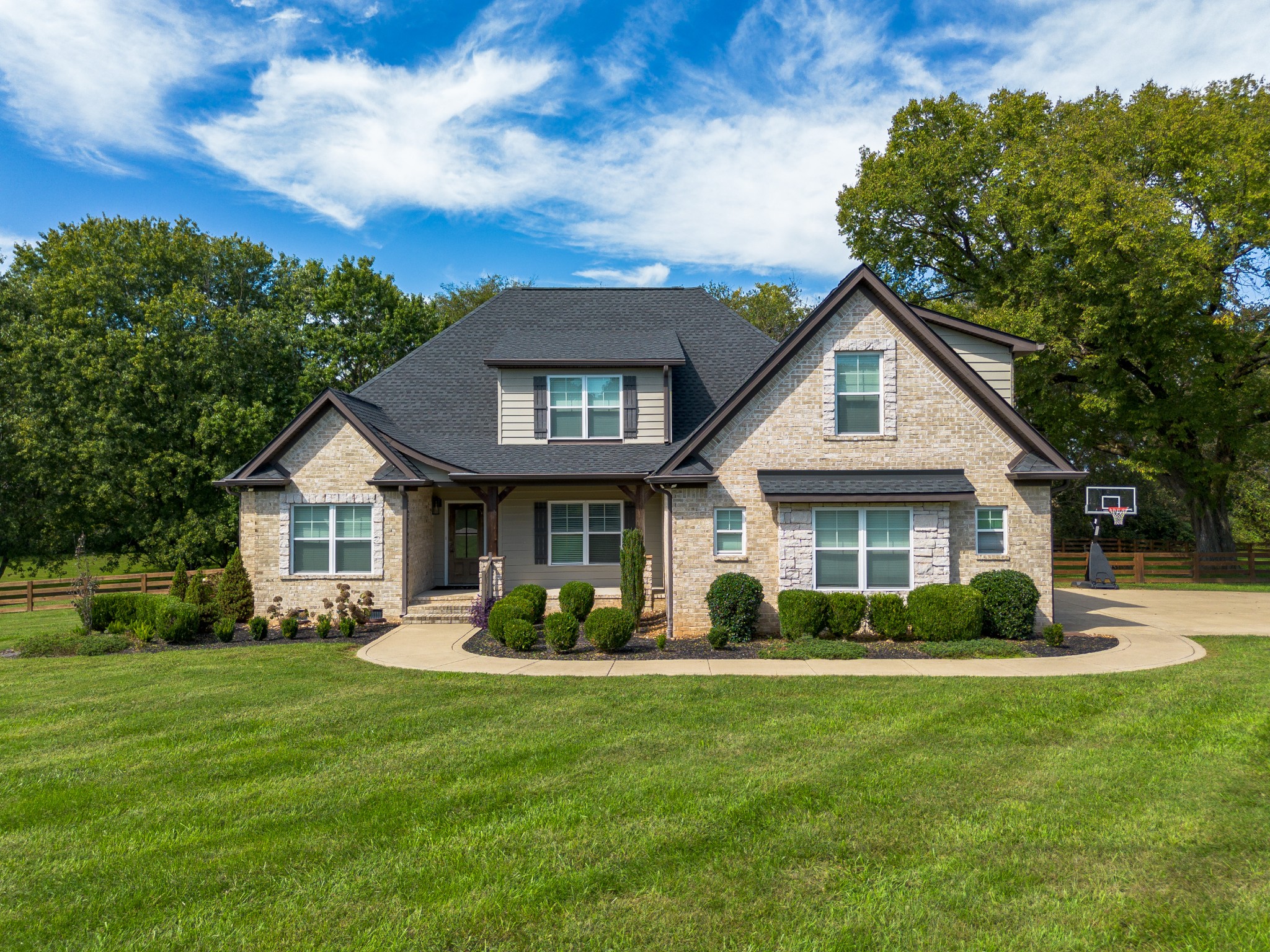 a front view of house with yard and green space