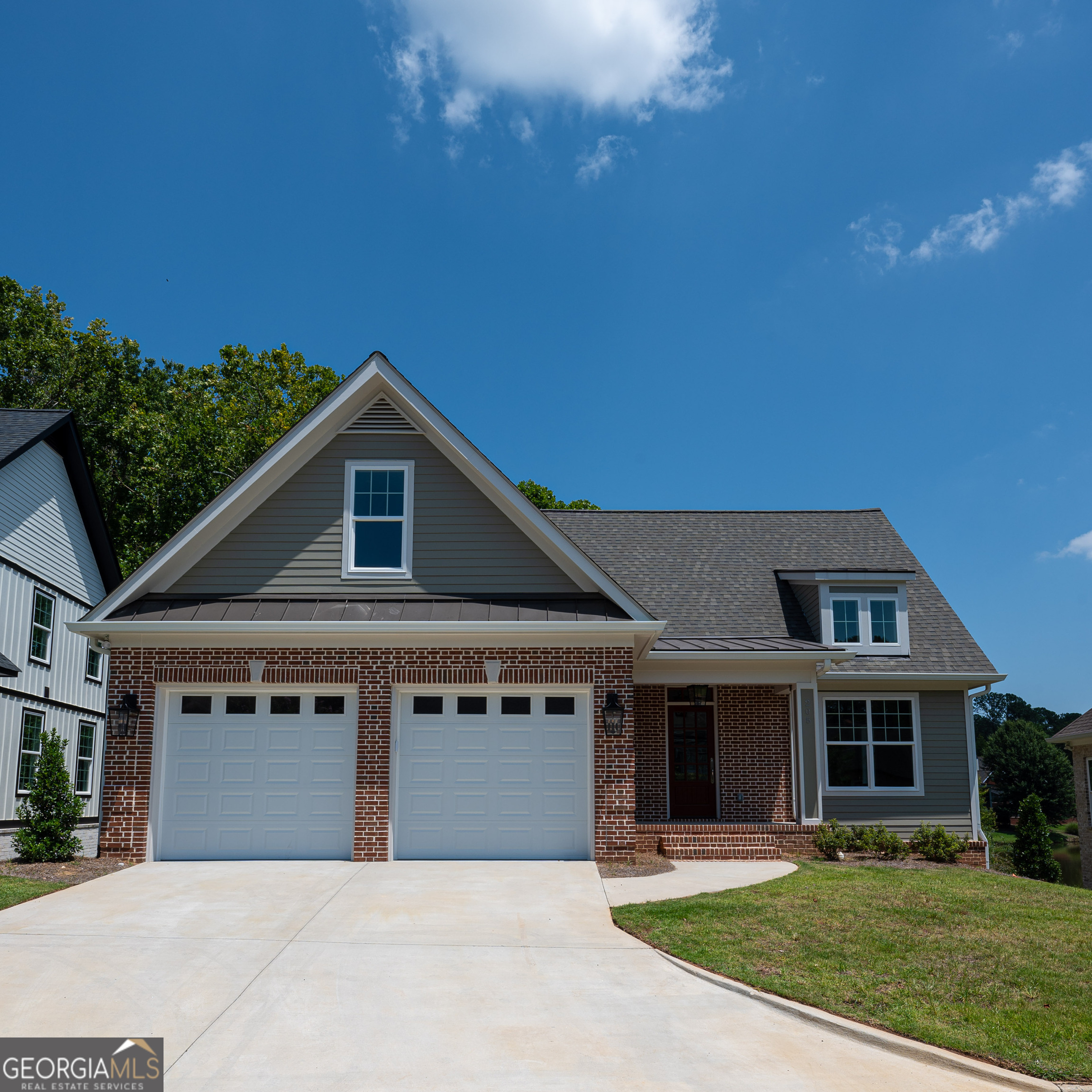 a front view of a house with yard and green space