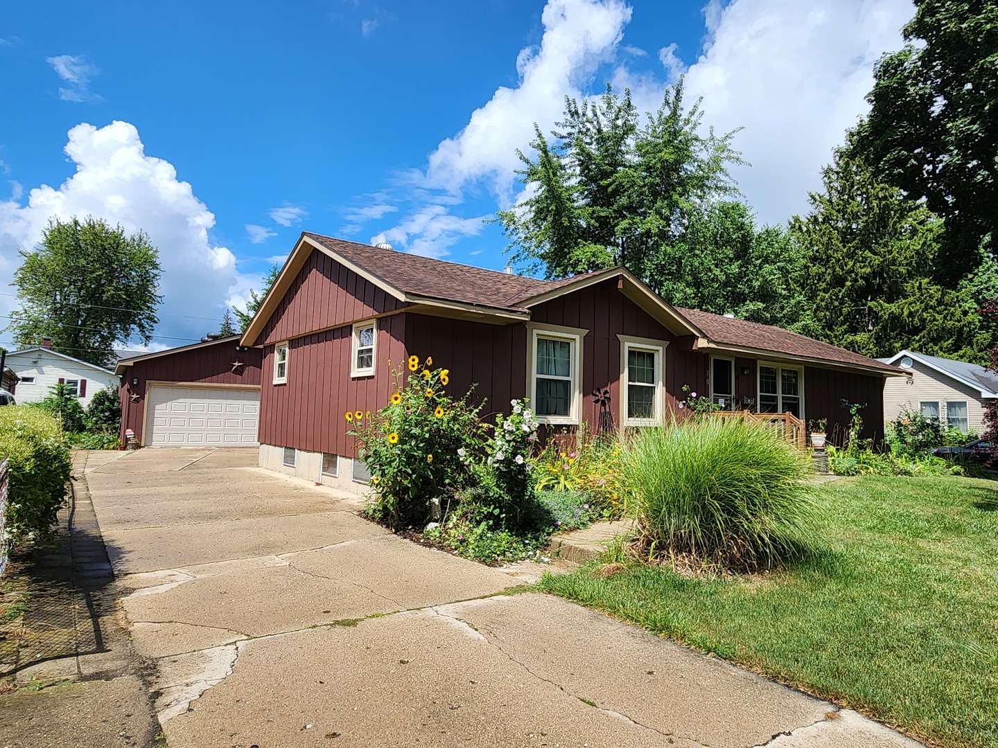 a front view of house with yard and green space