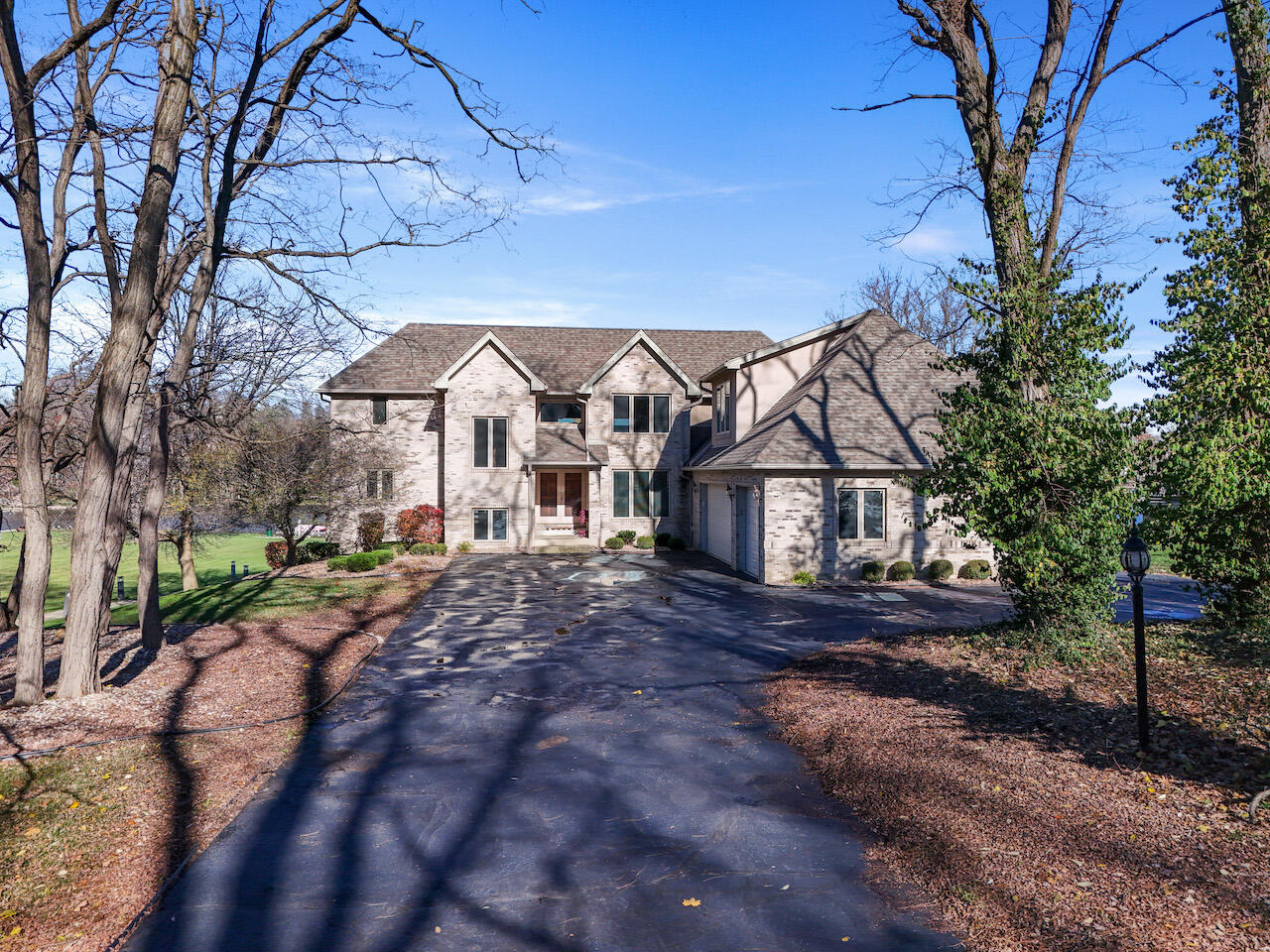 a view of a large house with a big yard and large tree