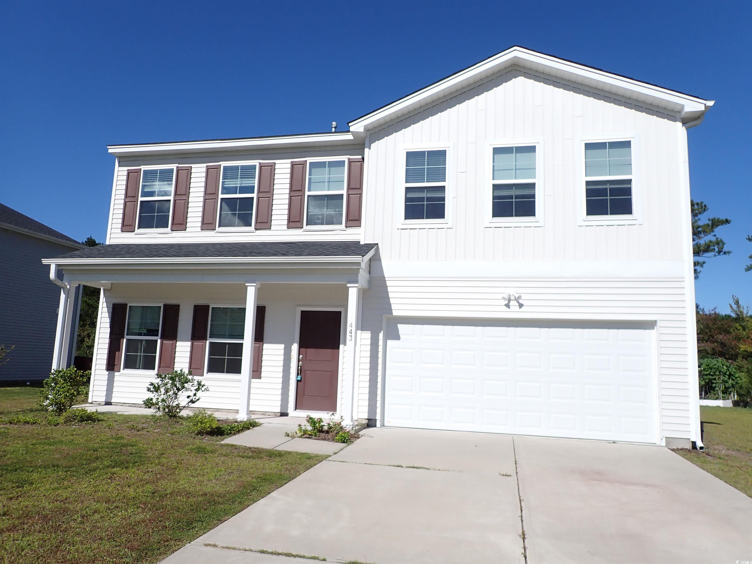 View of front facade featuring a front yard and a