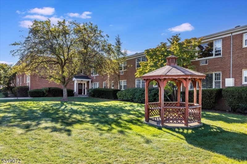 a view of a house with backyard porch and sitting area