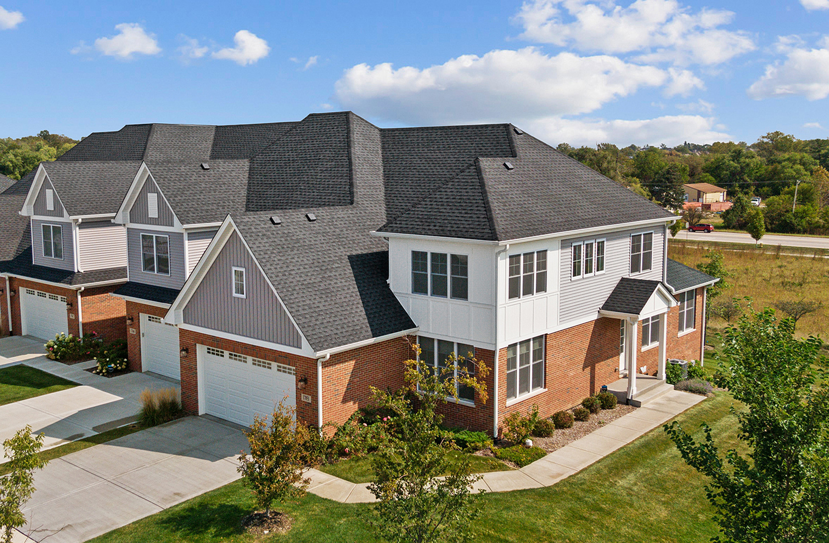 an aerial view of a house with a yard