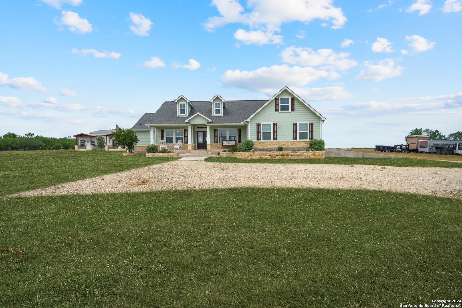 a front view of a house with a garden and yard