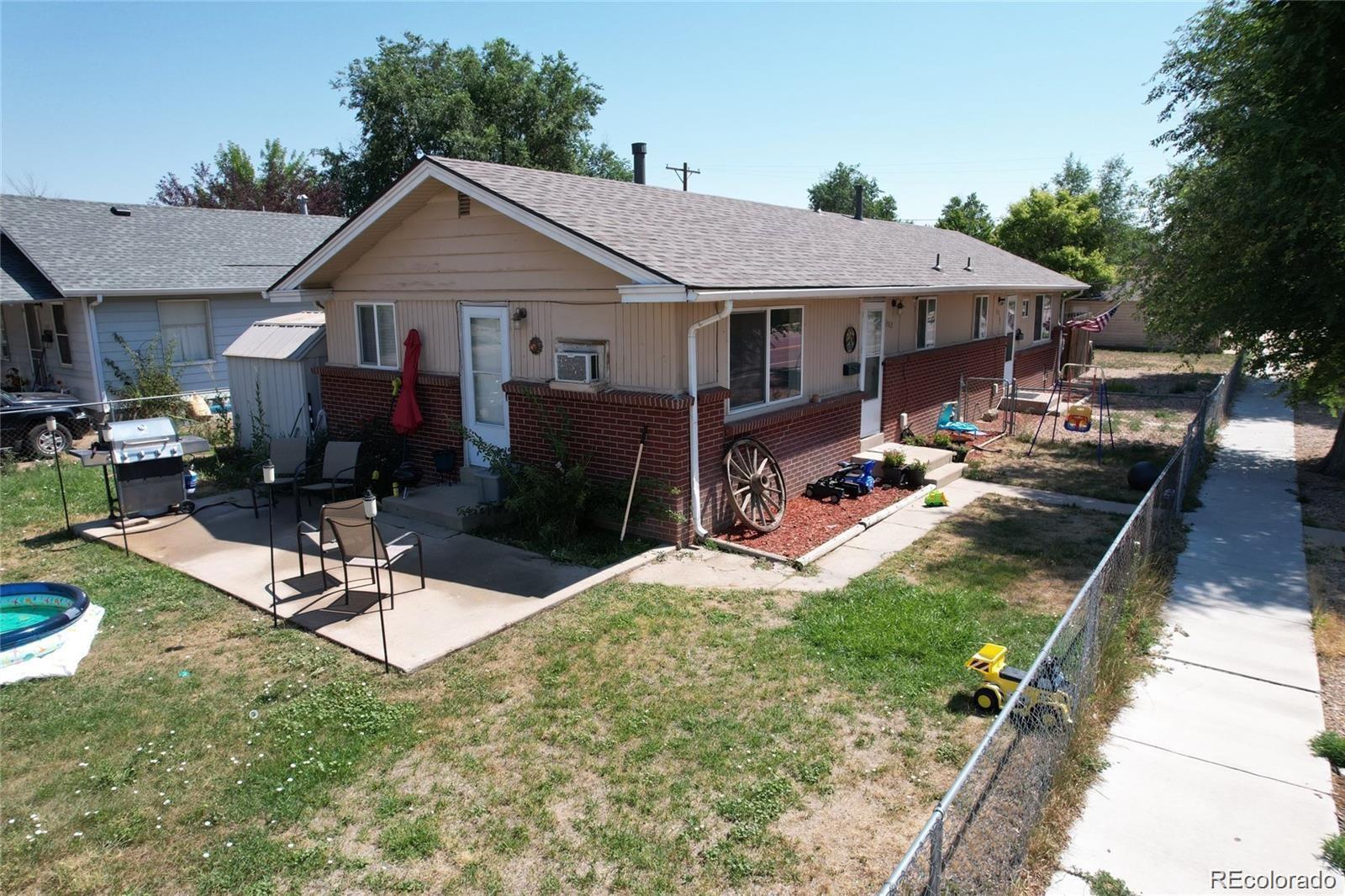 a aerial view of a house with garden bath tub and couches chairs