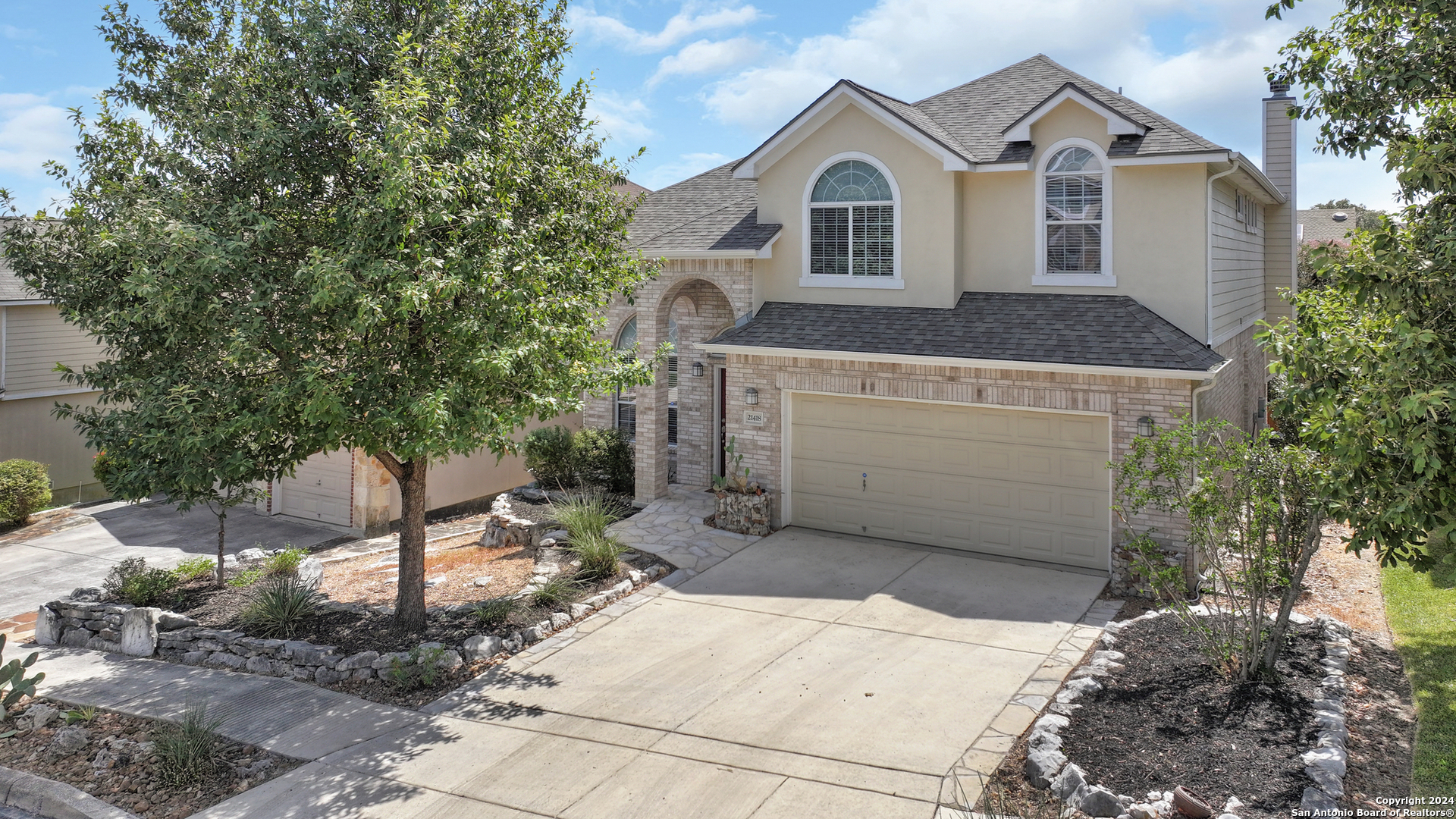 a front view of a house with a yard and garage