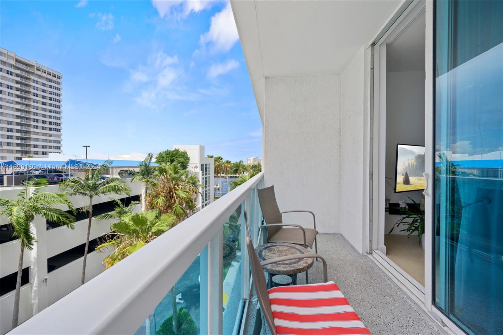 a balcony with wooden floor and outdoor seating