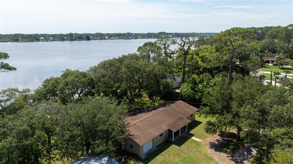 an aerial view of a house with a lake view