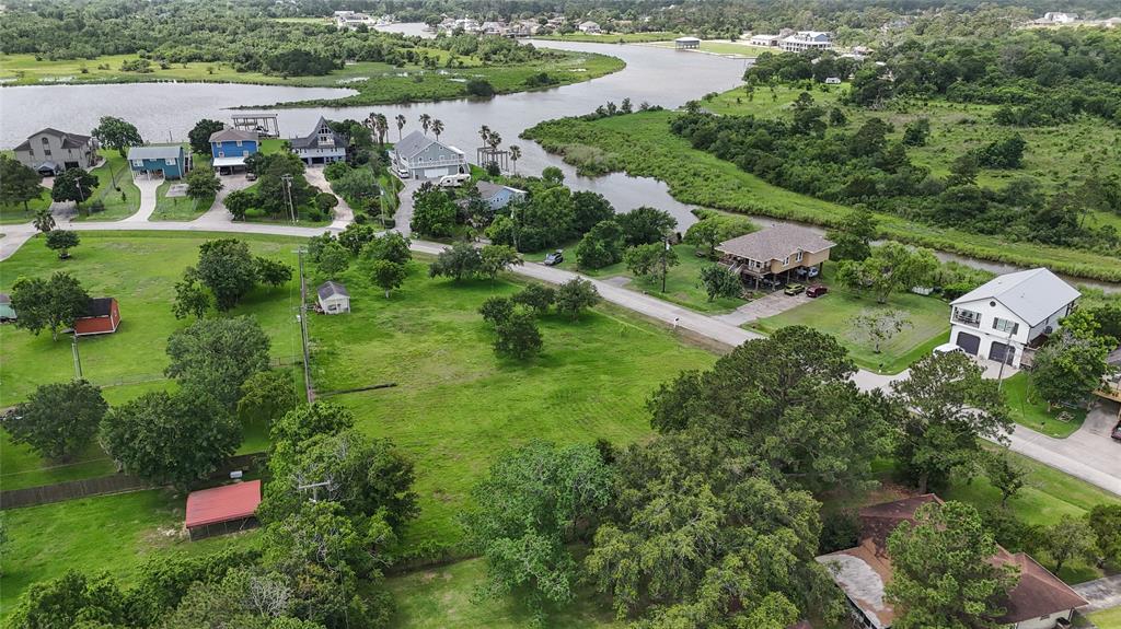 an aerial view of residential house with outdoor space and trees all around