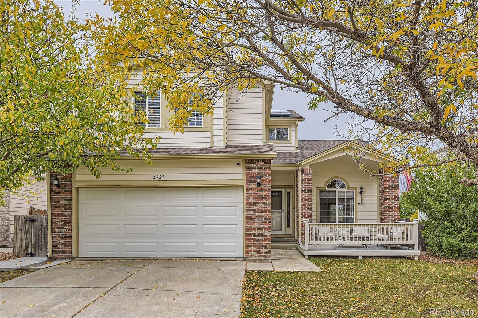 a front view of a house with a yard garage and outdoor seating