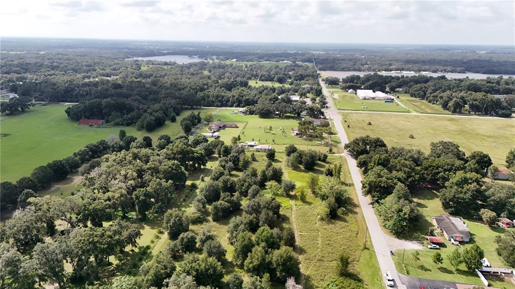 an aerial view of residential building and lake view in back