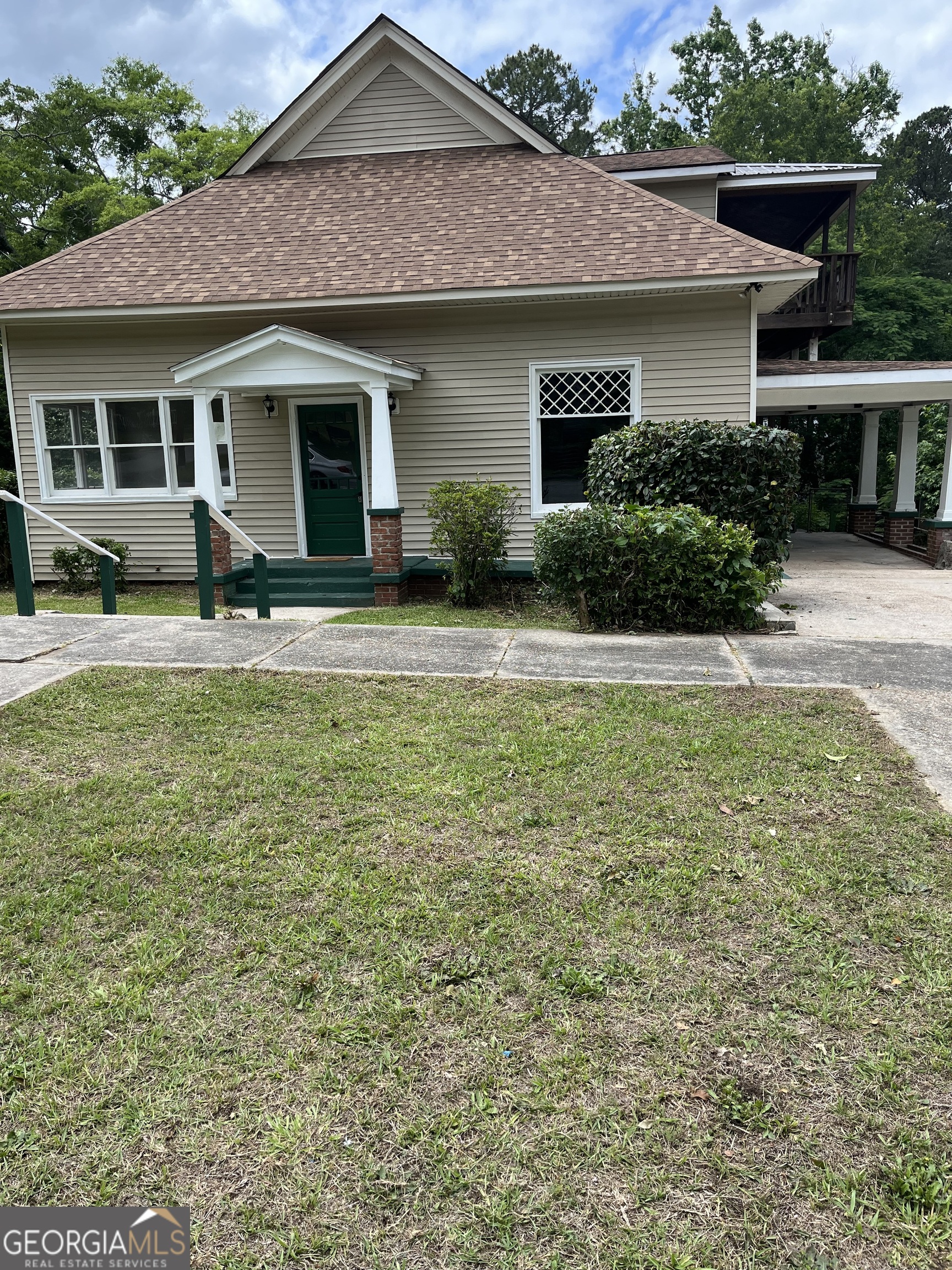 a front view of a house with a garden